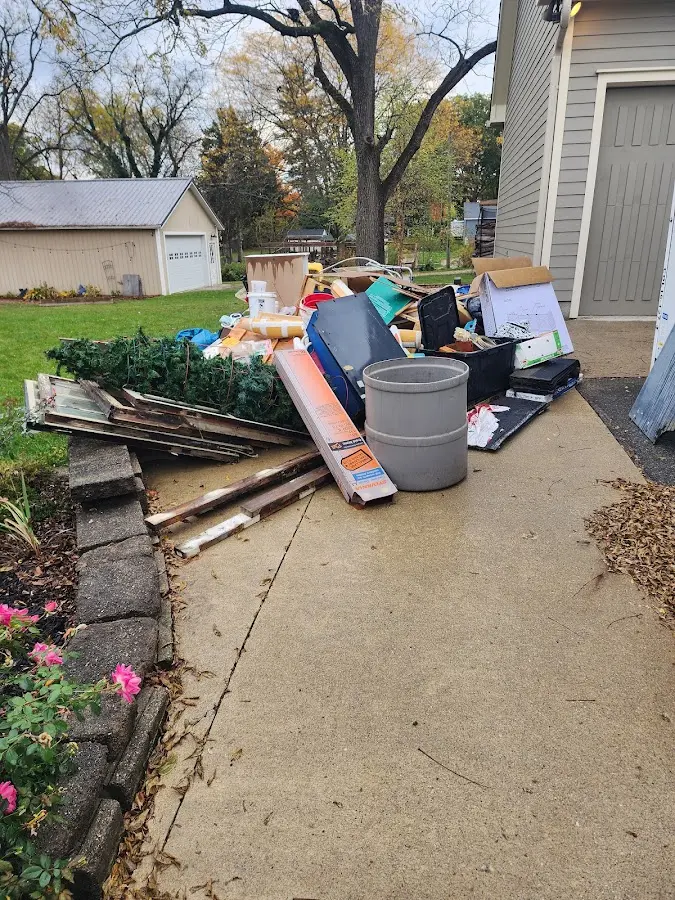 Dumpster being loaded with debris for 3 Yard Dumpster Rental in Huxley